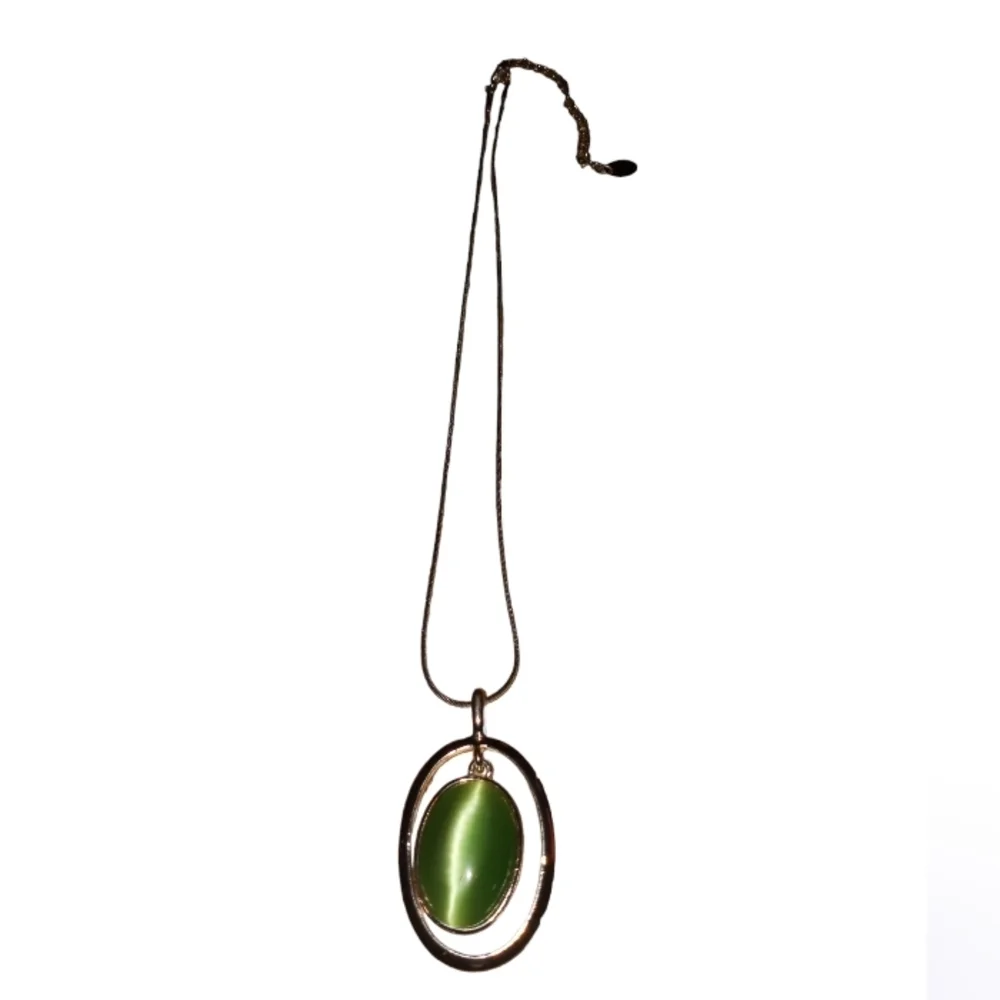 Claire's silver necklace with a green cat's eye pendant